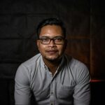 man in gray dress shirt wearing black framed eyeglasses